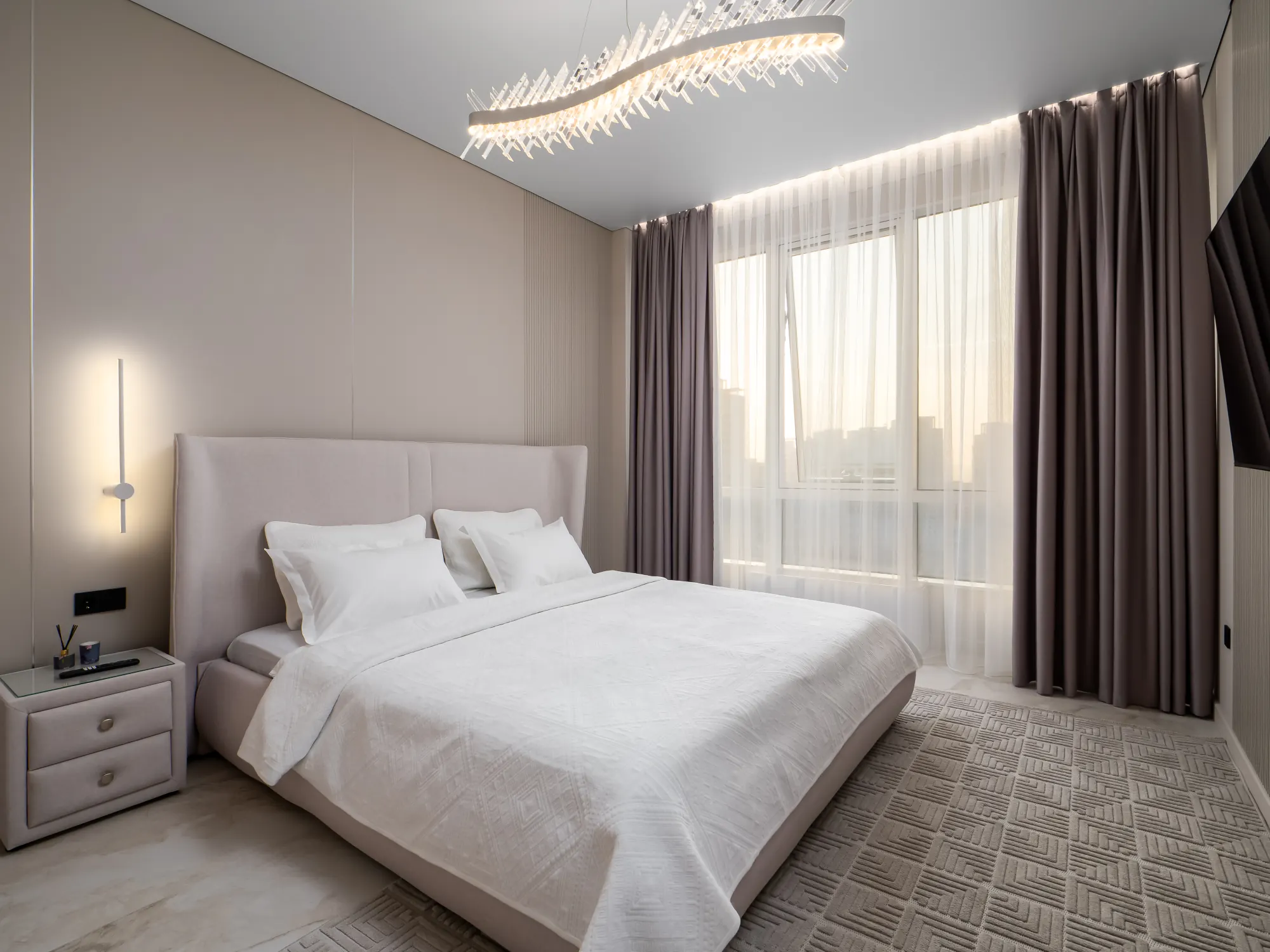 Wide bedroom view with sheer and blackout curtains
